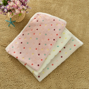Detail showing plush polka dot pet blankets in pink, cream and grey soft fleece