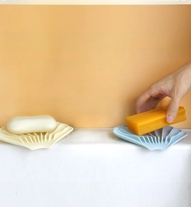 Detail showing shell-shaped silicone soap dish with non-slip ridges for water drainage