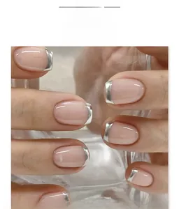 Close-up of nude pink short square fake nails with metallic silver French tip detail