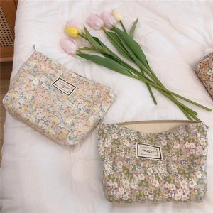 Detailed view of floral cotton makeup bags with zippers and Time to Party labels