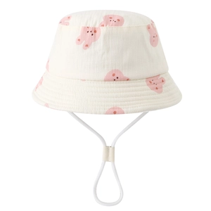 Detail of baby sun hat featuring pink rabbit patterns and adjustable chin strap