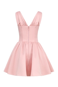 Detail of pink satin mini dress with deep V-neckline and elegant pleated waist design