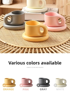 Detail of minimalist ceramic fat mug and saucer sets in orange, pink, gray, and white matte finish