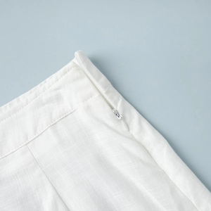 Close-up of white cotton skirt waist with fine texture and invisible zipper detail