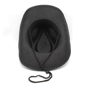 Detail view of black woven straw cowboy hat interior with adjustable chin strap