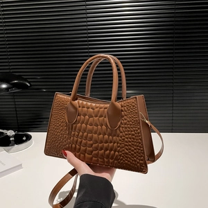 Brown crocodile embossed tote bag with gold hardware and shoulder strap for women