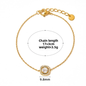 Detail of gold chain bracelet featuring a square clear stone pendant with halo setting