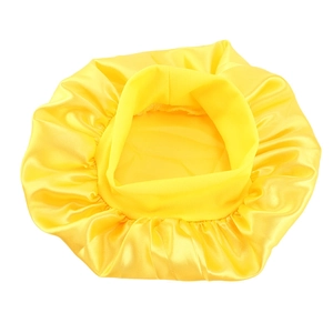 Bright yellow satin sleeping cap for kids featuring a shiny texture and elastic band