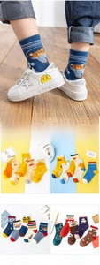 Detail of assorted cotton kids socks with cartoon animal patterns and ribbed cuffs