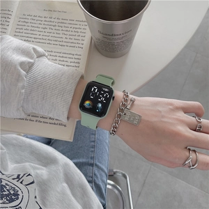 Mint green silicone digital watch with astronaut icon and stylish silver chain bracelet