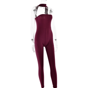 Detail of dark red backless halter jumpsuit with matching neckpiece on mannequin
