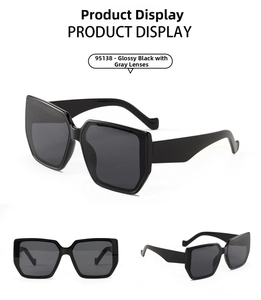Detail view of large square black frame sunglasses with dark grey polarized lenses