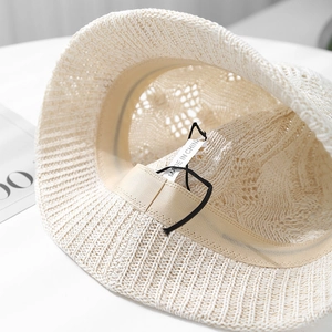 Close-up of the beige knit bucket hat interior showing texture and sweatband detail