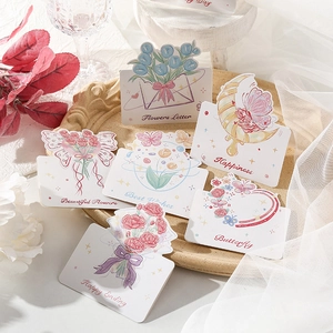 Detailed view of six floral greeting cards with hand-drawn illustrations on a tray