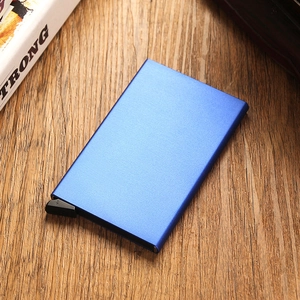 Detailed macro view of the blue matte metal RFID card holder on a dark wooden surface