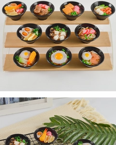 Detailed macro view of realistic mini Japanese Udon ramen pendants with tempura and egg