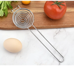 Macro shot of stainless steel egg separator with spiral filter on marble surface