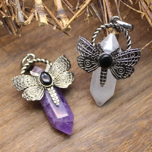 Detail of vintage butterfly pendants with amethyst and white crystal hexagonal pillars