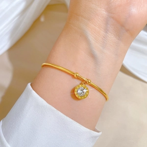 Elegant gold titanium steel bracelet with Roman numeral pendant and sparkling zircon stone