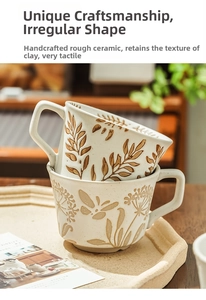 Detail of handcrafted stoneware coffee mug with brown botanical leaves and dandelion patterns