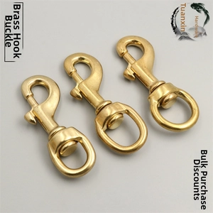 Macro view of solid brass swivel lobster clasps for bags and DIY hardware accessories