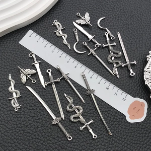 Detailed view of DIY silver zinc alloy sword and snake pendants with size measurement