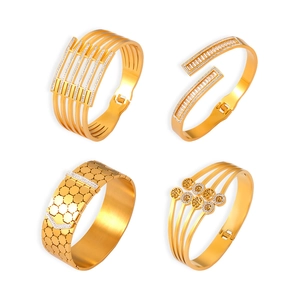 Set of gold-plated titanium steel bangles with hollow patterns and sparkling crystals