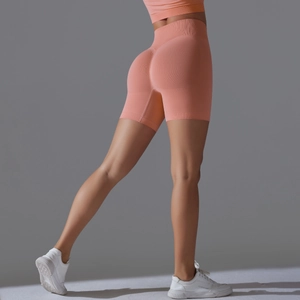 Detail of high waist seamless yoga shorts with scrunch butt lifting in salmon pink