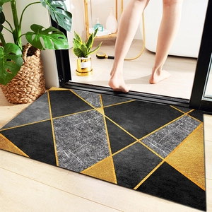 Absorbent bathroom rug with geometric design on wood floor near monstera plant