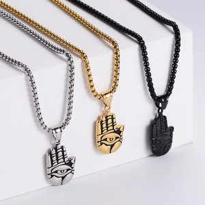 Detailed view of Hamsa Hand pendants in silver, gold, and black finishes with all-seeing eye