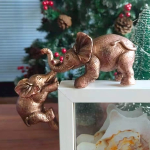 Modern bronze elephant resin statues on picture frame with festive holiday decor