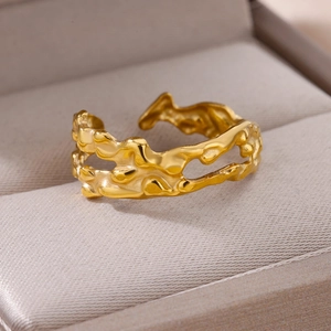 Macro detail of adjustable gold lava ring with fluid texture in a jewelry box