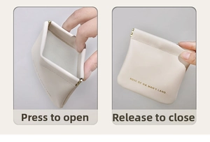 Detailed view of cream PU leather squeeze bag showing automatic self-closing spring clip