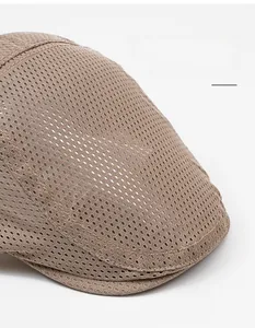 Close-up of breathable mesh fabric and wide brim on khaki summer flat cap