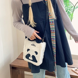 Cute panda plush crossbody bag with colorful rainbow strap shown in lifestyle scene