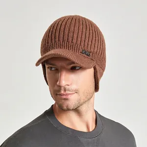 Men's winter knit beanie hat with visor and ear protection in dark brown caramel color