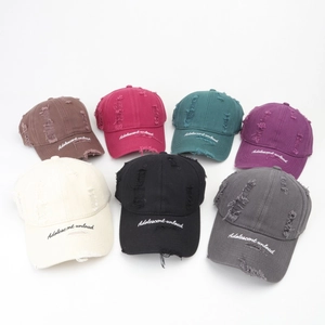 Distressed cotton baseball caps with embroidered letters in seven different colors