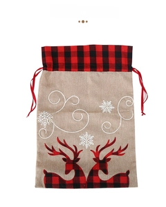 Detail of red and black plaid reindeer design on natural burlap Christmas gift bag