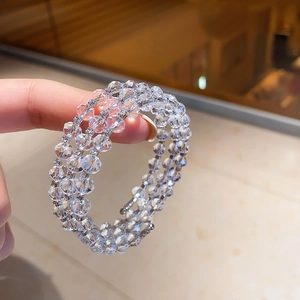 Macro shot of triple-layer crystal beaded bracelet with faceted beads and metal spacers