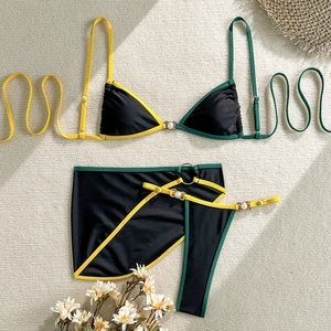 Detailed view of 3-piece bikini set with pearl gold rings and vibrant contrast trim