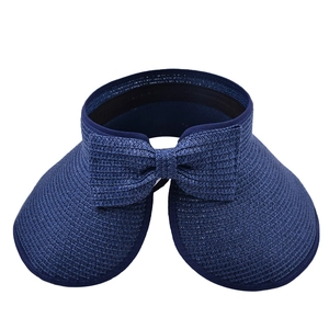Close-up of navy blue straw sun visor with stylish bow detail and tight weave pattern