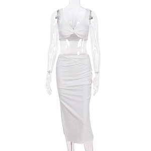 Close-up of a white two-piece crop top and ruched midi skirt set on mannequin