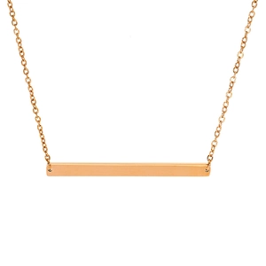 Detail of a minimalist gold bar pendant on a delicate chain necklace with metallic luster