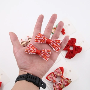 Close-up of festive red Christmas bow hair clips and reindeer hairpins for girls