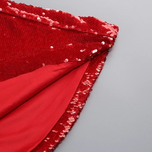 Macro shot of sequin fabric texture and lining detail on a red mermaid evening dress