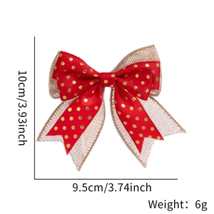 Close-up of burlap and red satin Christmas bow with gold dots for gift wrapping DIY