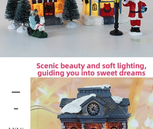 Detailaufnahme eines leuchtenden LED-Weihnachts-Miniaturhauses mit Schneeeffekt