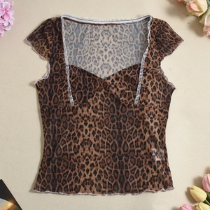 Close-up of leopard print sheer mesh top featuring white lace trim and ruffled edges