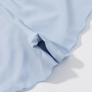 Detail of light blue high-elastic fabric with scalloped edges and seamless stitching