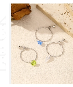 Detailed macro view of S925 sterling silver chain rings with colorful geometric charms